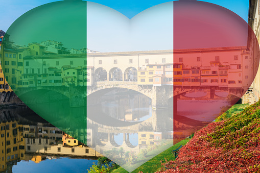 Ponte Vecchio, old bridge, in Florence, Tuscany, Italy with an Italian heart-shaped flag composed on sunny autumn day