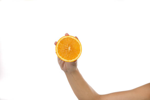 istock Human hand with citrus fruit in the studio 1199884189