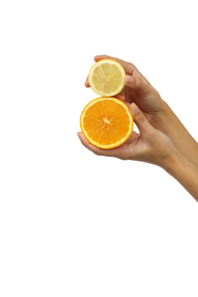 istock Human hand with citrus fruit in the studio 1199884231