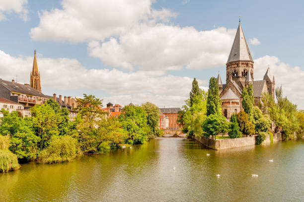 Iconic view of Protestant Temple Neuf on Ile du Petit-Saulcy island surrounded by Moselle river, Metz, France
