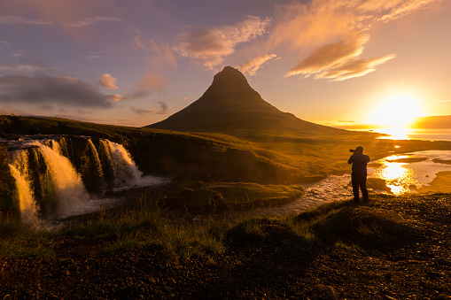 Scenic view silhouette of Photographer taking photo Kirkjufellsfoss at morning, Travel Destinations Concep