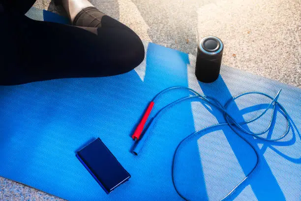 Top view of a woman relaxing on a mat after workout.