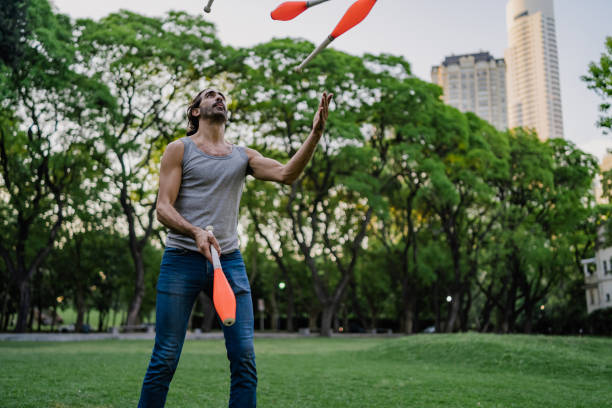 istock Man juggling with cones in park 1199887467