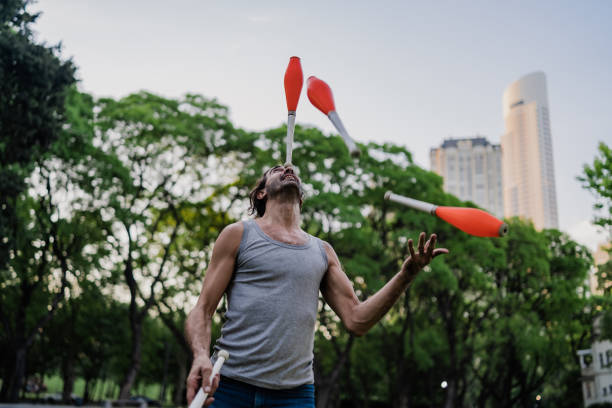istock Man juggling with cones in park 1199887488