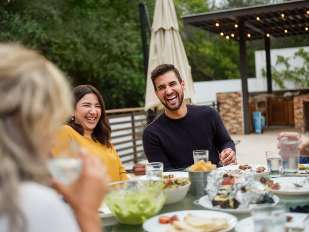 istock Friends having fun eating together 1199887988