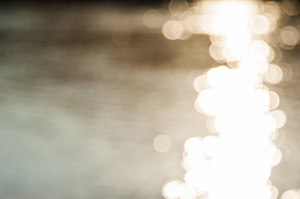 istock the golden sunlight shines bright and reflects on water. it causes glittering effect on the water surface. the ripples on water are appeared as beautiful background. 1199888630