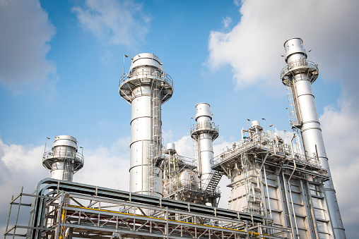 Drone stock photo of a big factory with smoking chimneys.