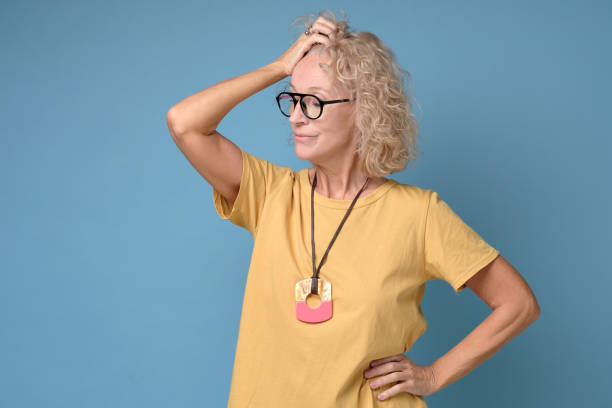 istock Mature woman in yellow clothes thinking about her life problems being sad 1199889497