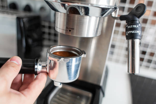 istock Guy prepare delicious aromatic coffee in a coffee machine. A simple way to make coffee 1199891111