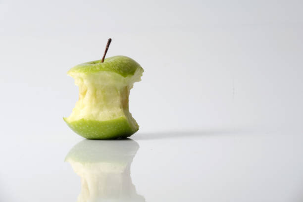 istock Apple bite from a ripe green apple isolated on white 1199891392