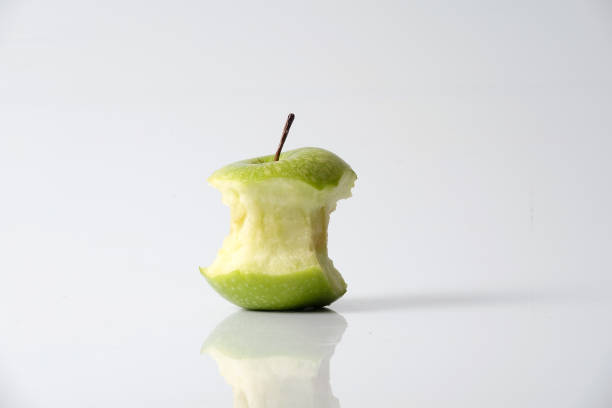 istock Apple bite from a ripe green apple isolated on white 1199891403