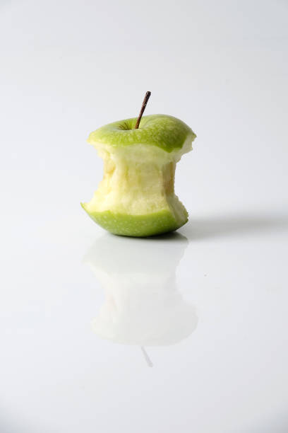 istock Apple bite from a ripe green apple isolated on white 1199891411