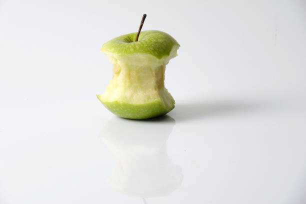 istock Apple bite from a ripe green apple isolated on white 1199891412