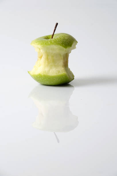 istock Apple bite from a ripe green apple isolated on white 1199891415