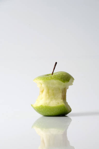 istock Apple bite from a ripe green apple isolated on white 1199891422