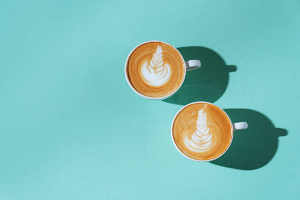istock two Cup of coffee on color background. 1199892504