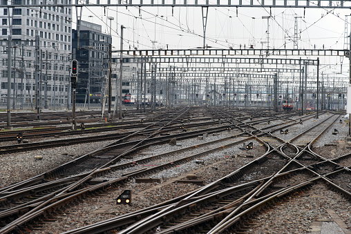 Zurich Mainstation with Railroad Tracks and Trains. The image shows many crossings and electric cables for trains entering and leaving to the main railway station of zurich.