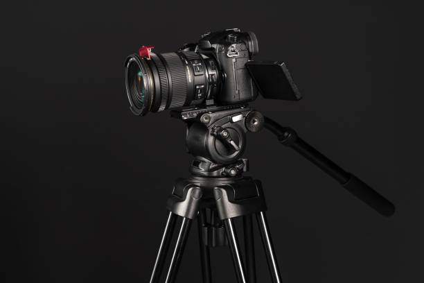 istock DSLR mirrorless camera on tripod on black studio background 1199894181