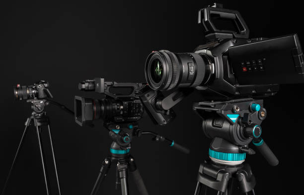 istock Three different types of video cinema photo camera on black background, side view 1199894265