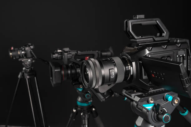 istock Three different types of video cinema photo camera on black background, close-up 1199894321