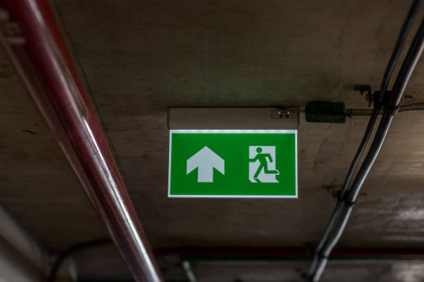 istock Green emergency exit sign showing the way to escape.Fire exit in the building. 1199894322