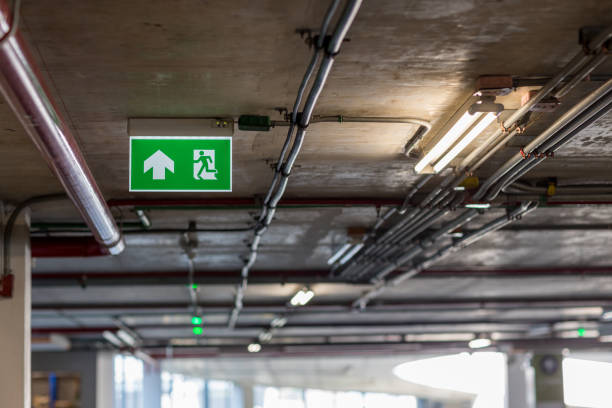 istock Green emergency exit sign showing the way to escape.Fire exit in the building. 1199894324