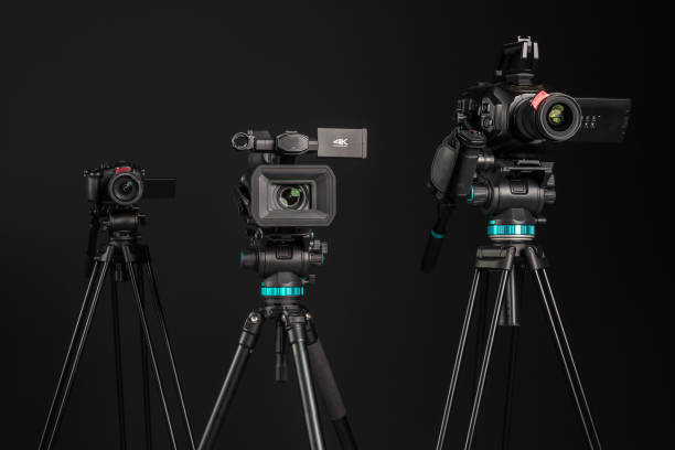 three different types of video cinema photo camera on black background, close-up - television camera tripod media equipment videography imagens e fotografias de stock