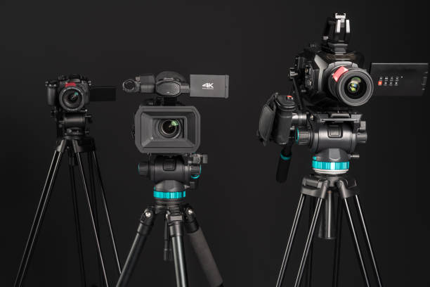 istock Different types of video cinema photo camera on black background, front view 1199894657
