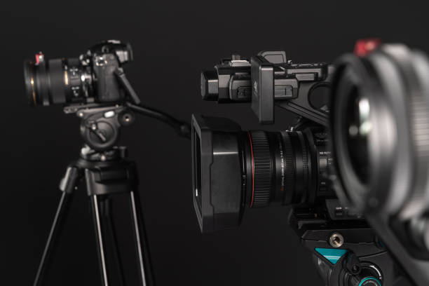 three different types of video cinema photo camera on black background - television camera tripod media equipment videography imagens e fotografias de stock