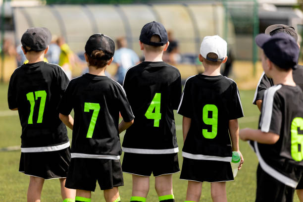 istock Kids Soccer Team Waiting On The Bench 1199894753