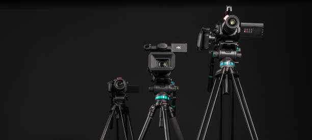 istock Three different types of video cinema photo camera on black background, copy space 1199894757