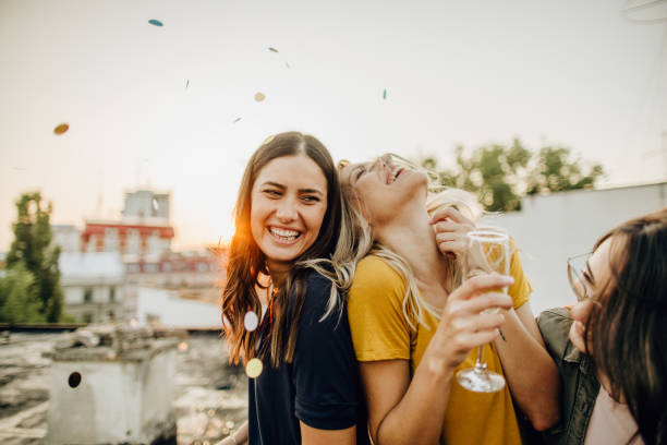 Celebration time Photo of girlfriends on the rooftop, celebrating their friendship white wine photos stock pictures, royalty-free photos & images