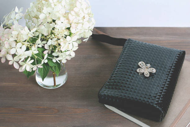 istock composition on a dark wooden background. bouquet of white hydrangeas and a notebook. close up 1199895550