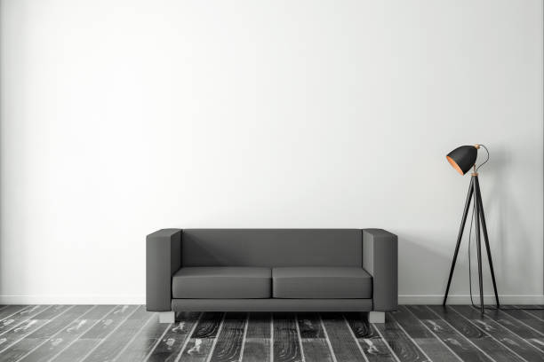 istock Black Sofa in empty room with modern lamp 1199896090