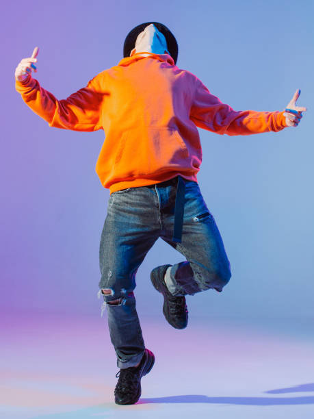 istock Guy dancing contemporary dance in studio. Neutral grey background. Acrobatic bboy dancer. 1199898610