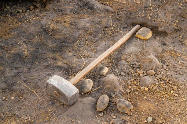 istock Dirty sledgehammer on soil and sand 1199899238