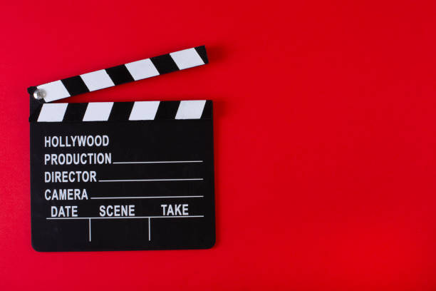 istock Movie clapper board on red background with copy space. 1199899293