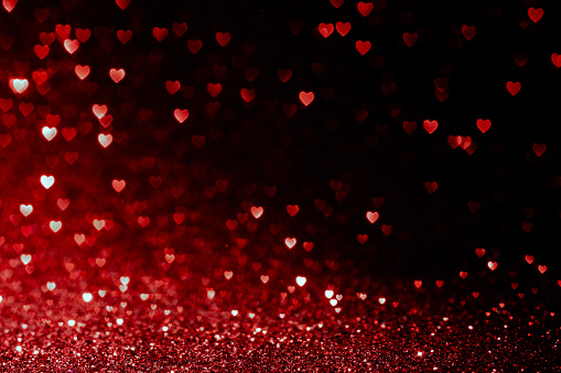 Photo of valentines day background with red hearts glitter bokeh on black, card for Valentine's day, christmas and wedding celebration, Love bokeh shiny confetti textured template