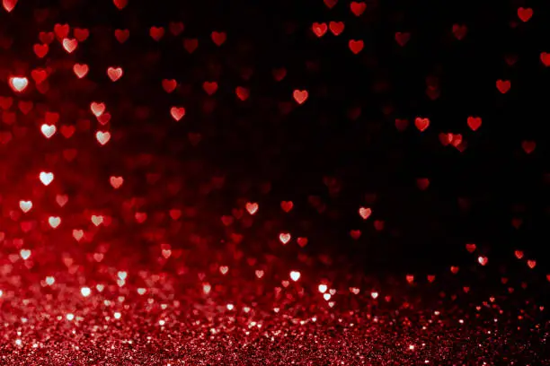 Photo of valentines day background with red hearts glitter bokeh on black, card for Valentine's day, christmas and wedding celebration, Love bokeh shiny confetti textured template