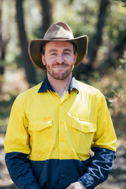 Happy Working in the Australian Forests Portrait of a man wearing a bush hat looking and smiling at the camera. park ranger stock pictures, royalty-free photos & images