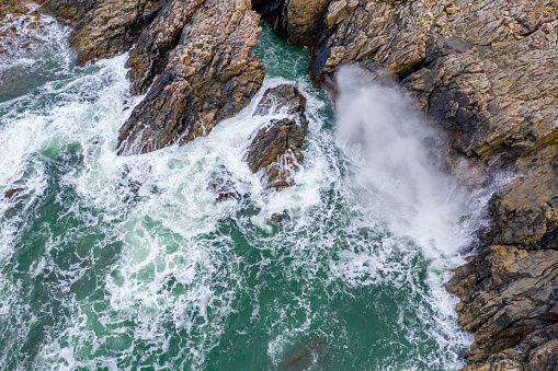 Atlantic waves splash against the rock at the Donegal coast in Ireland.