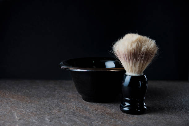 黒い背景の石の表面にシェービングブラシとボウル - shaving equipment wash bowl bathroom razor ストックフォトと画像