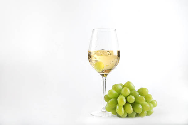 wine glass with grapes and white wine - white wine wine white glass imagens e fotografias de stock