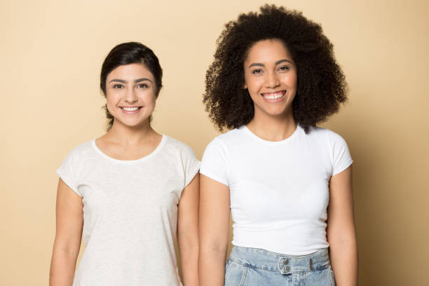 istock Two happy diverse multiracial millennial ladies standing side by side. 1199905411