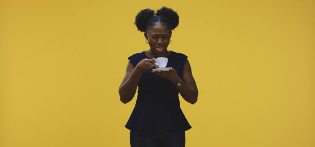 jeune femme buvant le café - disgust women african ethnicity human face photos et images de collection