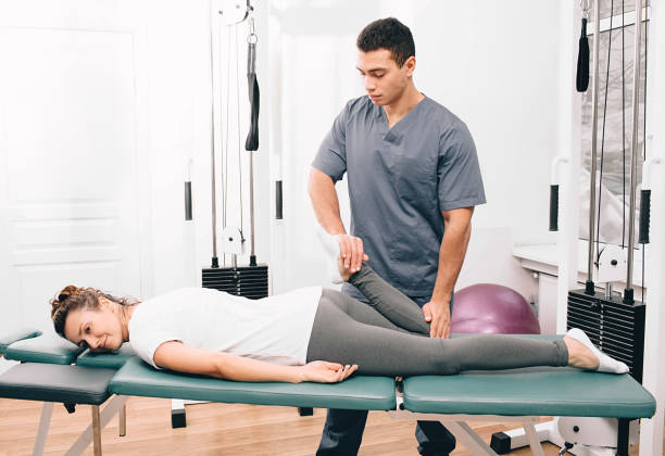 istock woman visiting her physiotherapist. Patient doing exercise for joint treatment 1199908839