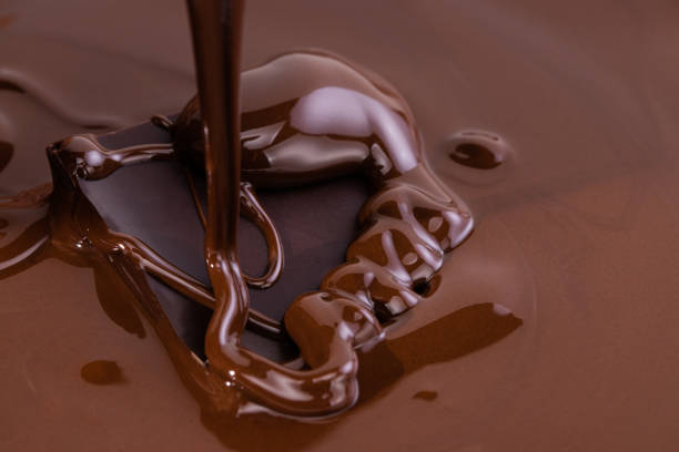 istock Melted chocolate swirl background. Liquid chocolate close-up 1199908867