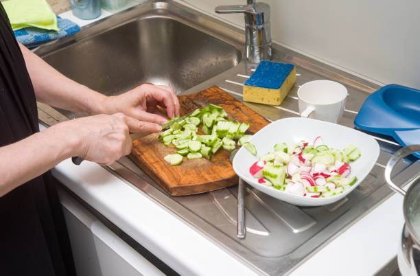 istock Female hands chopping salad 1199910281