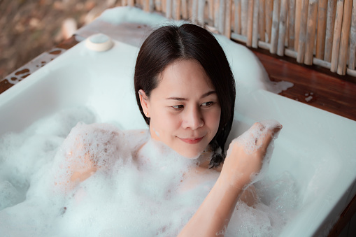 Woman relaxing in tub.