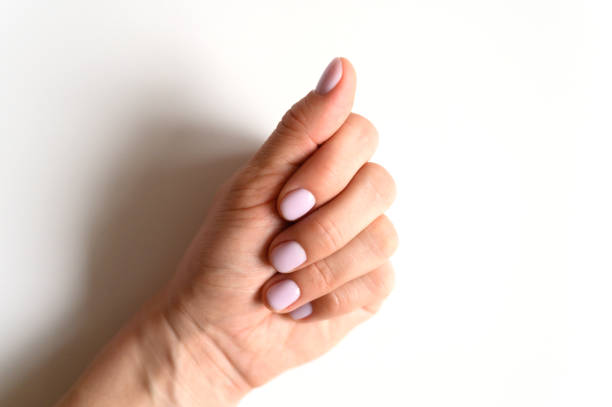 istock woman's hand with pale lilac painted nails on a white background 1199912734
